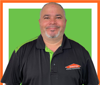 Luis, male, SERVPRO employee against green background