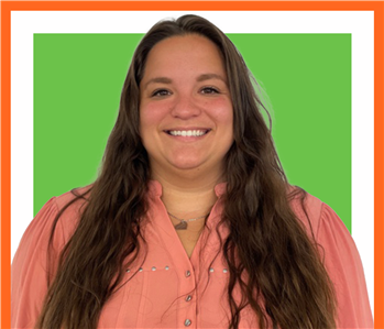 Jaymyne, servpro employee against a green background, woman