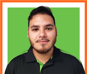 Daniel, male, SERVPRO employee, cut out, against a white background, SERVPRO green sign above head